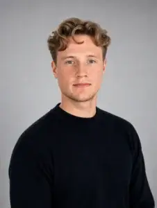 Portraitfoto eines Mannes mit Blonden kurzen leicht gelockten Haaren